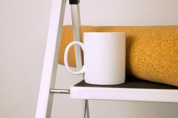 White coffee mug mockup with stepladder