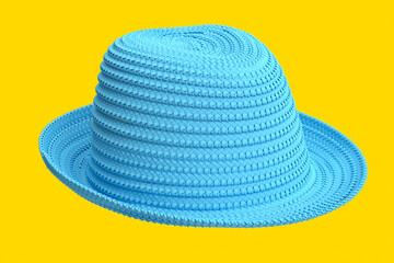 Vintage blue straw beach sun hat isolated on yellow and sun protection