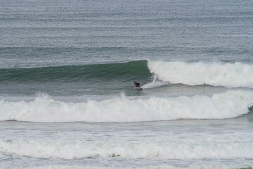 confirmed surfer in action in big waves