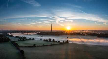Sunrise and the first rays of sunshine over the fog-covered Ruhr meadows in Duisburg, Germany - obrazy, fototapety, plakaty