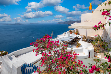 Naklejka premium Relaxing and romantic view with white architecture in Santorini Greece, caldera view over blue sea and volcano island. Summer landscape for travelling and vacation template. Luxury resort hotel famous
