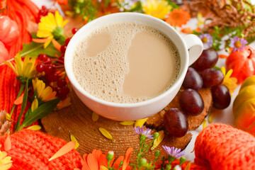 Autumn coffee cup flatly composition. Grapes, autumn leaves, flowers