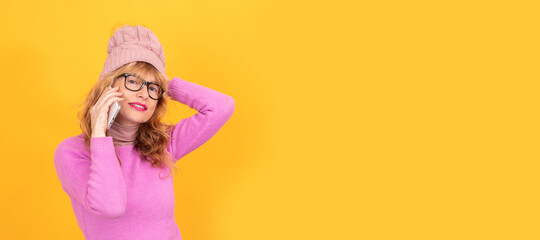 woman isolated on background wearing winter clothes talking on mobile phone, space for text