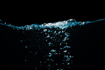 Water Surface with Ripple and Bubbles Float Up on Black Background. Water Wave