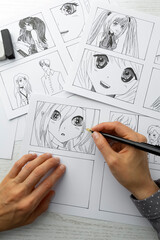 An artist draws a storyboard of an anime comics book. Manga style. - 462570361