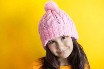 Happy beautiful smiling child girl in knitted hat. Space for text. Autumn consept.
