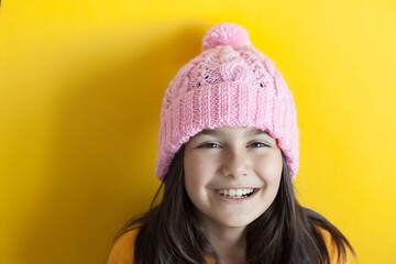 Happy beautiful smiling child girl in knitted hat. Space for text. Autumn consept.