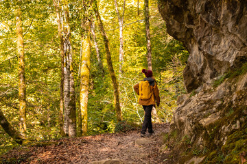 A young woman on the path to the Holtzarte suspension bridge, Larrau. In the forest or jungle of Irati, Pyrenees-Atlantiques of France