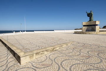 Statue of Gundisalvus and Traditional style Portuguese Calcada Pavement for pedestrian area in Lagos, Algarve, Portugal
