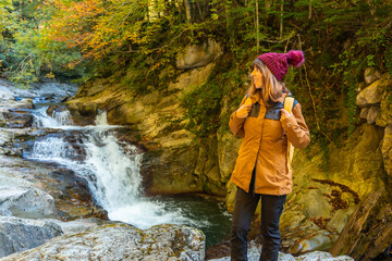 Irati forest or jungle in autumn, a young hiker in the Cubos waterfall. Ochagavia, northern Navarra in Spain