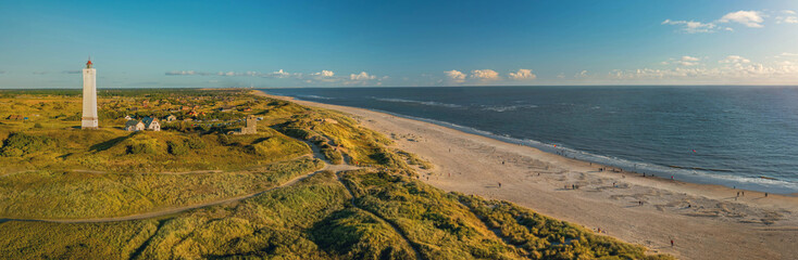 Panoramic view of Blåvand lighthouse on wide dune of Blåvandshuk with beach view on the west coast of Jutland, by Esbjerg, Denmark. - obrazy, fototapety, plakaty