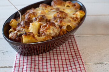 Casserole with italian meatballs, pasta, cheese and tomato sauce