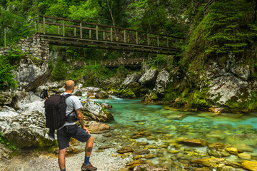 Tolmin Gorge Canyon, Soca Valley Slovenia. Adventure Hiker Looking at Suspension Bridge © marcin jucha
