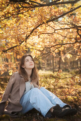 Young teenager girl in the autumn forest