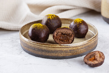 Obraz premium Truffles with orange in chocolate on a plate.
