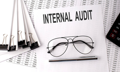 INTERAL AUDIT text on paper with chart and office tools , business concept