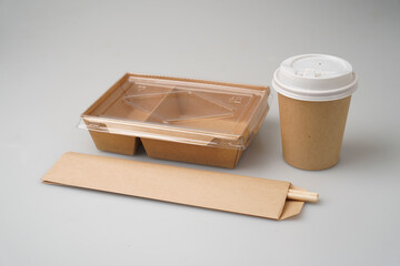 Empty craft paper disposable food boxes, coffee cup and disposable chopsticks mock up on white background. Delivery food concept.
