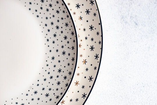Two porcelain Christmas plates with snowflake borders