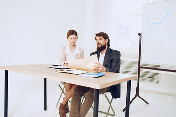 Fototapeta na wymiar business man and woman sitting at the table working office officials