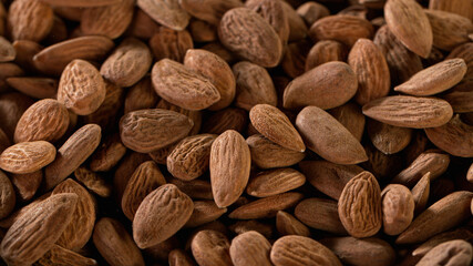 Raw organic almonds nuts, close-up, macro shot.