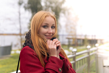 red-haired girl chilled in the autumn wind