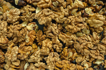 Background from a pile of peeled walnut halves. Top view