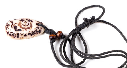 Handmade bone amulet, Siberia. Isolated on white background. Close-up. Top view.