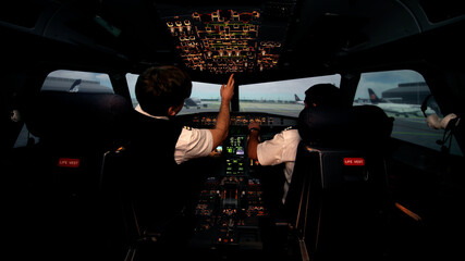Two caucasian male pilots in the cockpit or flight deck of passenger airplane © nimito