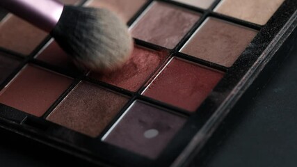 applying eye makeup, eye shadow and pigment to a makeup brush, the process of a makeup artist close-up, the use of beauty cosmetics