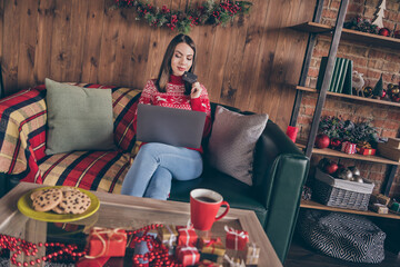 Photo of thoughtful lady hold debit card search pc network prepare buy noel presents in decorated x-mas home indoors