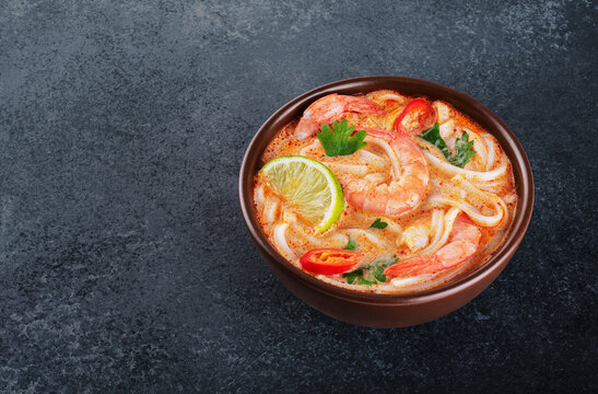 Tom Yum Noodle Soup With Spices And Shrimp On A Dark Background.