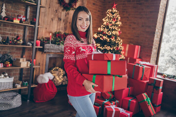 Photo of beautiful adorable young woman dressed red sweater putting gifts under new year tree smiling indoors room home house