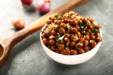 Street foods background- spiced fried chickpeas masala.