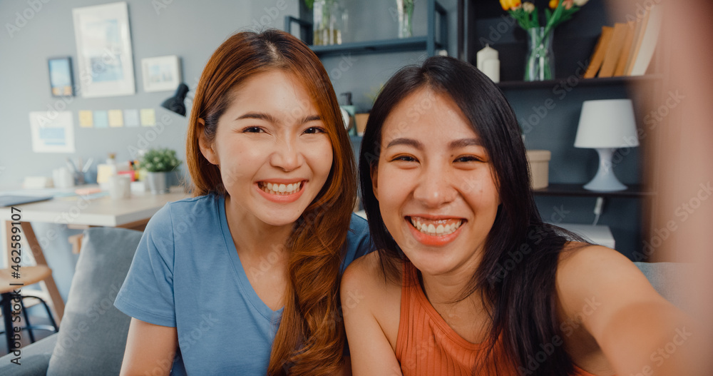 Wall mural teenager asian women feeling happy smiling selfie and looking to camera while relax in living room a