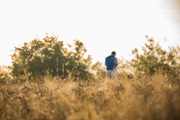 Man silhouette in the distance against the sunset