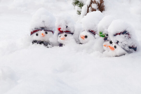 Fun cute snowmen dressed deep in snowfall