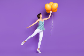 Fototapeta na wymiar Full length body size view of attractive cheerful girl holding balls dancing event isolated over bright purple violet color background