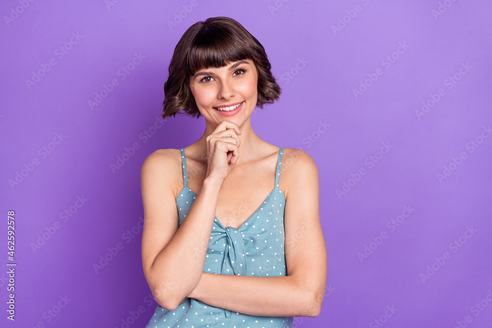 Wall mural Portrait of attractive cheerful girl thinking touching chin isolated over bright violet purple color background