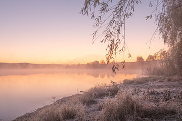 amazing sunrise landscape with morning fog in the forest lake reflected water autumn scenic view of lake in foggy weather, cold fall colors. wanderlust