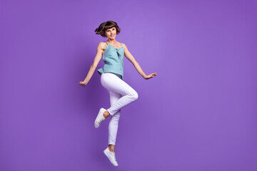 Fototapeta na wymiar Full length body size view of attractive cheerful girl jumping having fun isolated over bright violet purple color background