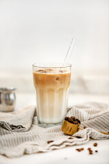 Iced latte coffee drink in tall glass over white background - 462592929
