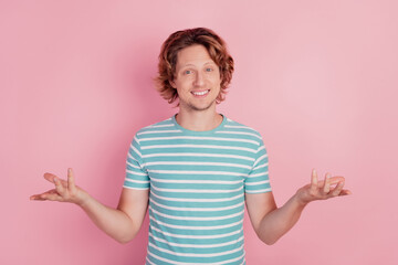 Photo of hospitable guy raise hands wear casual blue striped t-shirt on pink background