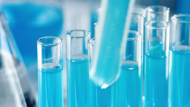 Medical Development Laboratory: Scientist placing test tubes into Laboratory rack. Advanced Scientific Lab for Medicine, Biotechnology Development. Close-up Shot