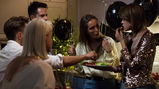 Friends drinking and eating at the party. Shot with RED helium camera in 8K