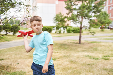 Little boy with airplane toy. Adventure fly concept. Stay home game. Family garden activity. Male...