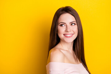 Photo of optimistic brunette lady look empty space wear pink shirt isolated on yellow color background
