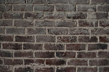 Old brick wall. Brickwork from an red old brick in a rustic style. The structure and pattern of the stone wall. Copy space.