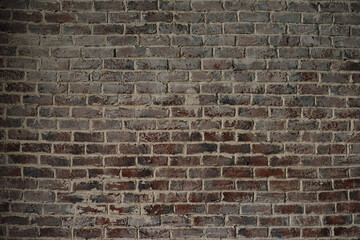 Old brick wall. Brickwork from an red old brick in a rustic style. The structure and pattern of the stone wall. Copy space.
