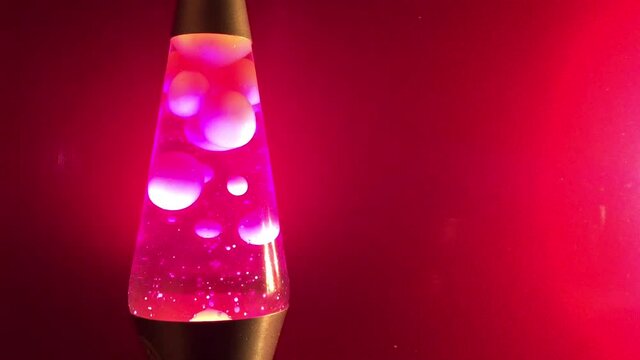 pink Lava lamp closeup 70s style pink lava liquid and pink background stock footage with copy space