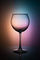 empty glass goblet on a gradient background